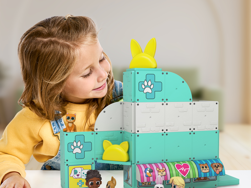 Girl playing with her Tile Town Pet Clinic Rescue Toy set.