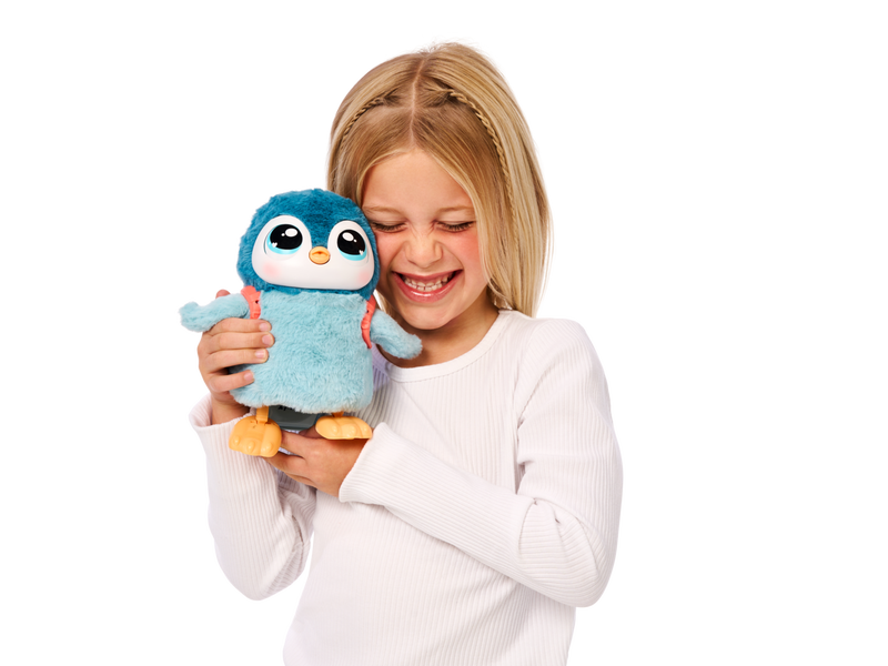 Girl holding her Little Live Pets My Baby Penguin Toy. 